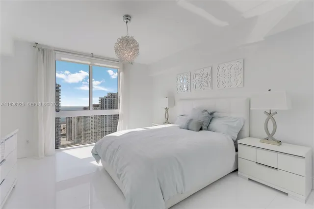 a bedroom with a large bed and a large window