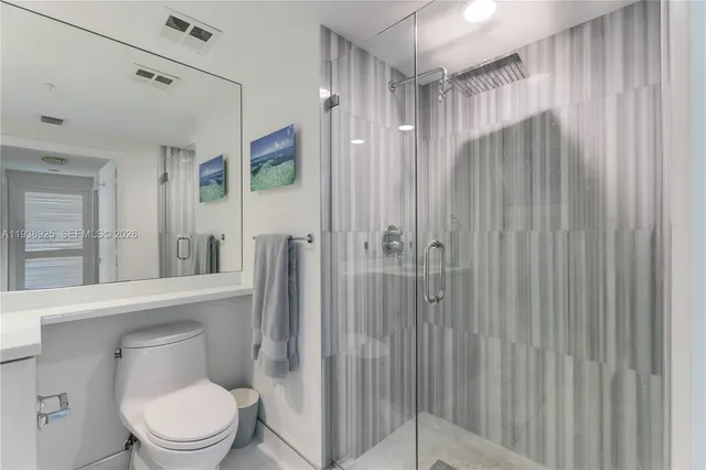 a bathroom with a toilet a sink and shower