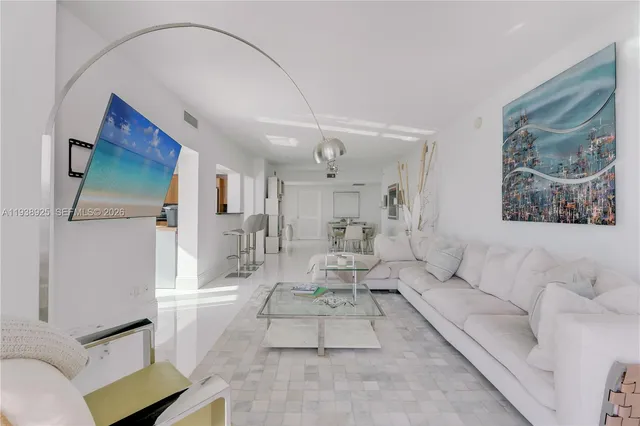 a living room with furniture and a painting