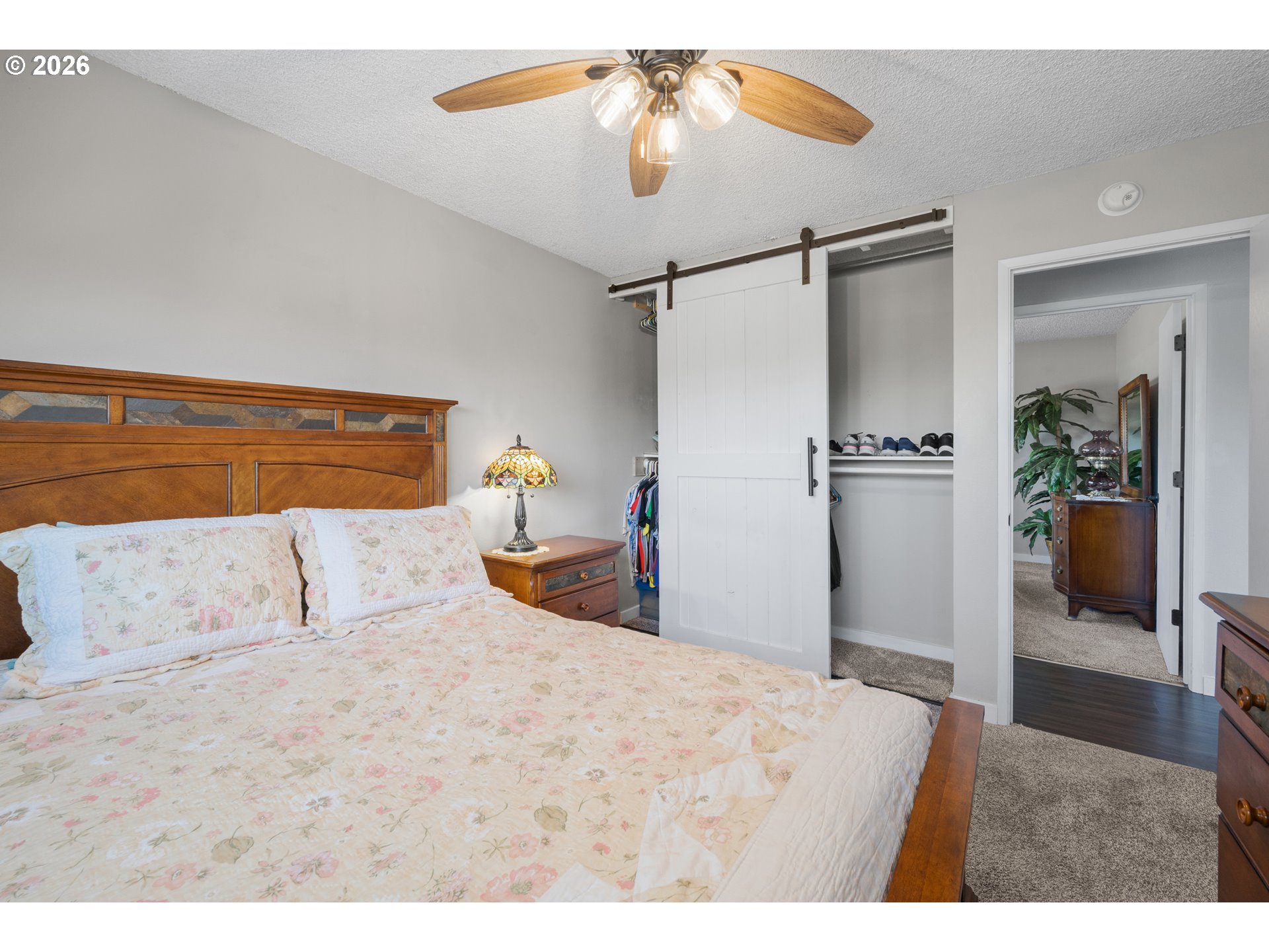 2727 Gateway Street, Unit 18 Springfield, OR 97477 - Photo 19 of 34 a bedroom with a bed and a chandelier