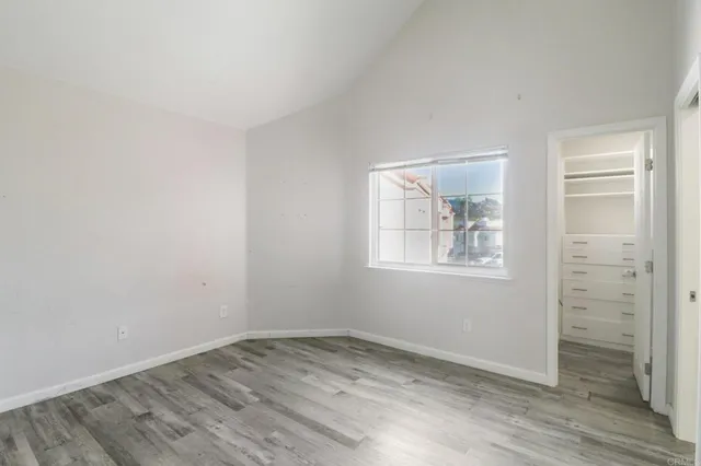 an empty room with windows and closet