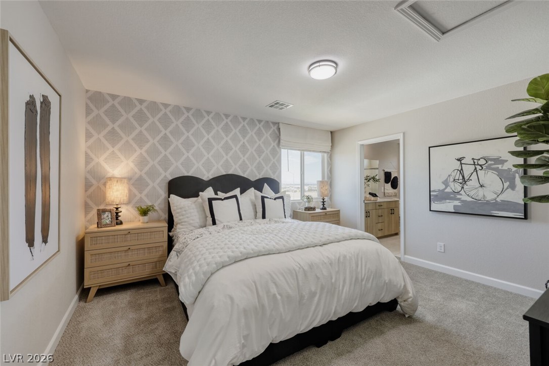 911 Cadence View Way Henderson, NV 89011 - Photo 15 of 28 This primary bedroom offers a soothing atmosphere and an adjacent private bathroom.