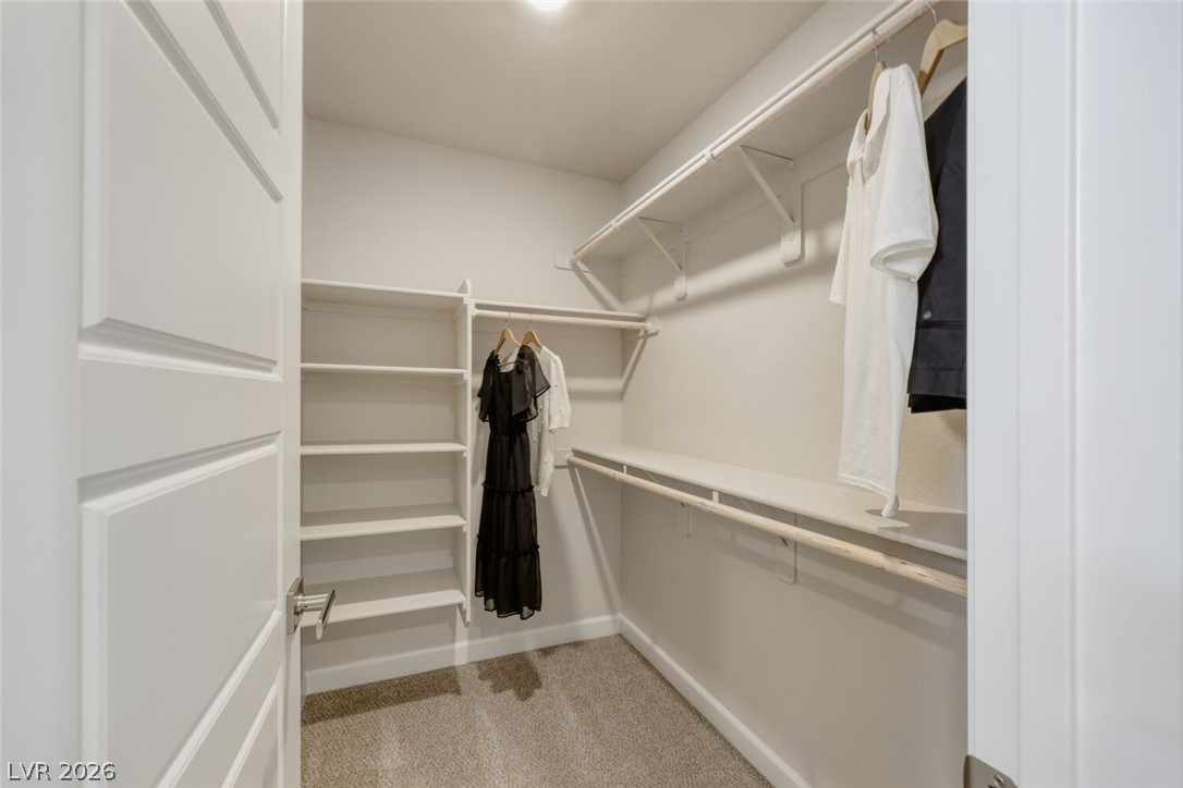 911 Cadence View Way Henderson, NV 89011 - Photo 17 of 28 This organized walk-in closet features ample shelving and hanging space for effortless storage.