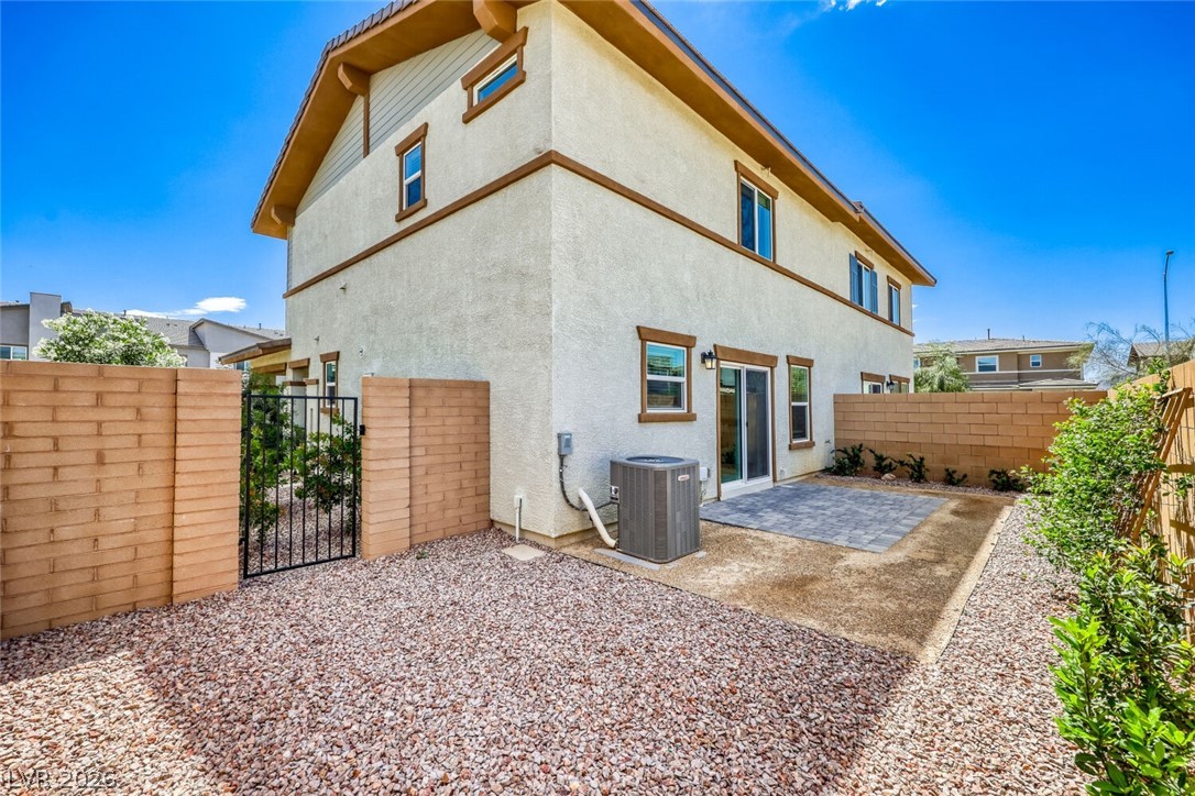 911 Cadence View Way Henderson, NV 89011 - Photo 19 of 28 This residence showcases a well-maintained exterior, offering a private yard space for outdoor enjoyment.