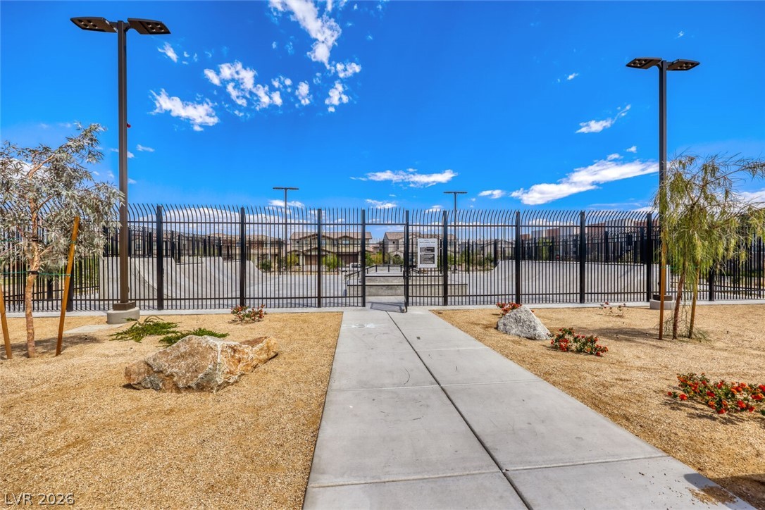 911 Cadence View Way Henderson, NV 89011 - Photo 22 of 28 This community entrance boasts a secure gated entry, concrete path, and drought-tolerant landscaping.