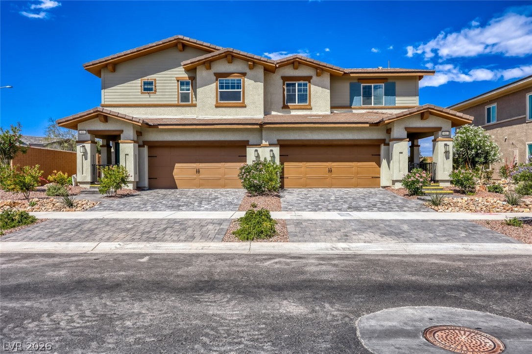 911 Cadence View Way Henderson, NV 89011 - Photo 27 of 28 This charming duplex boasts inviting exteriors and attached garages, offering comfortable living spaces.