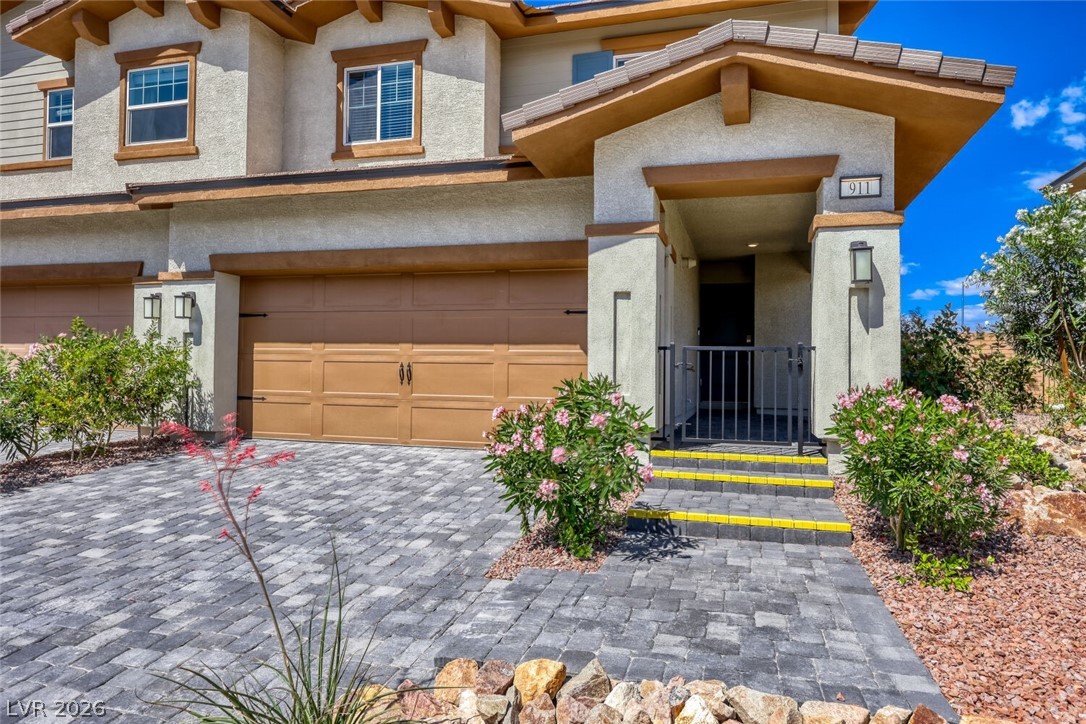 911 Cadence View Way Henderson, NV 89011 - Photo 28 of 28 This residence features a paver driveway, an attached garage, and a welcoming entryway.