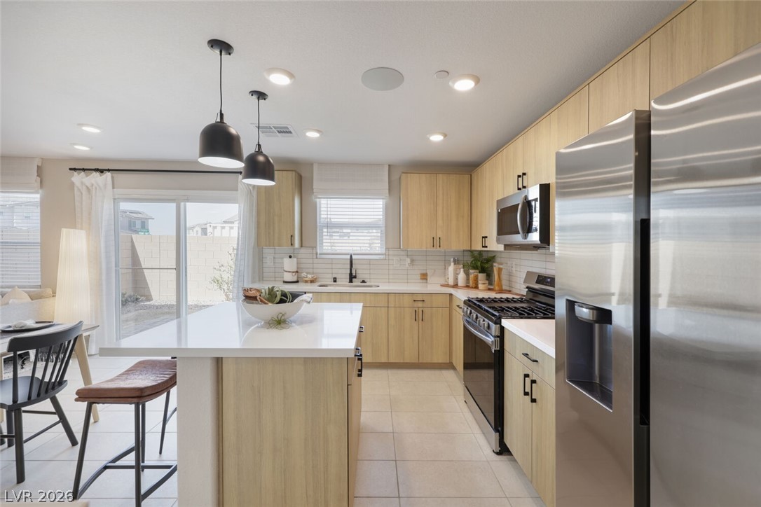 911 Cadence View Way Henderson, NV 89011 - Photo 4 of 28 This functional kitchen features ample counter space and modern appliances, perfect for everyday living.