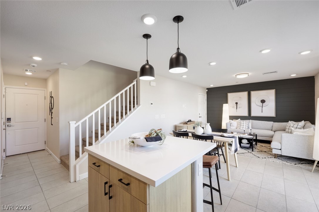 911 Cadence View Way Henderson, NV 89011 - Photo 5 of 28 This open concept living area boasts a kitchen island and seamless flow to the living and dining spaces.