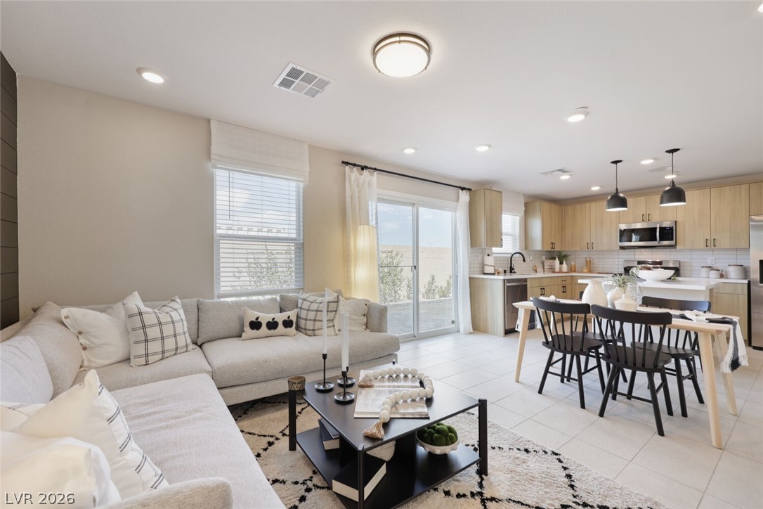 911 Cadence View Way Henderson, NV 89011 - Photo 6 of 28 This luminous open-concept space seamlessly blends comfort and culinary delight.