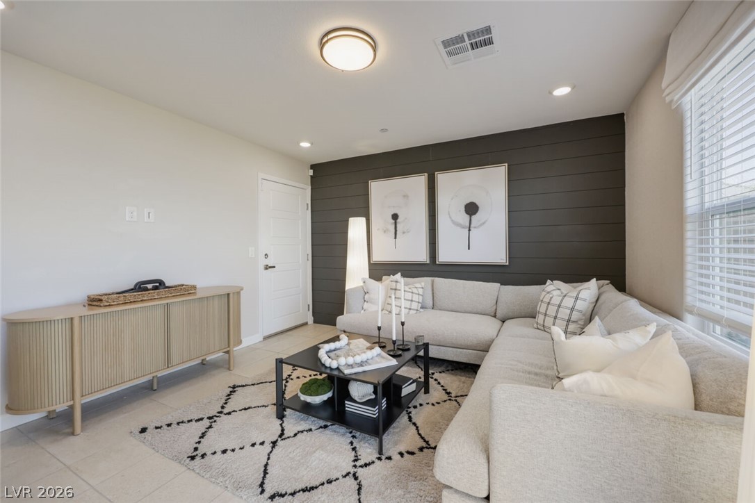 911 Cadence View Way Henderson, NV 89011 - Photo 7 of 28 This inviting space features elegant flooring and thoughtful lighting for comfortable living.