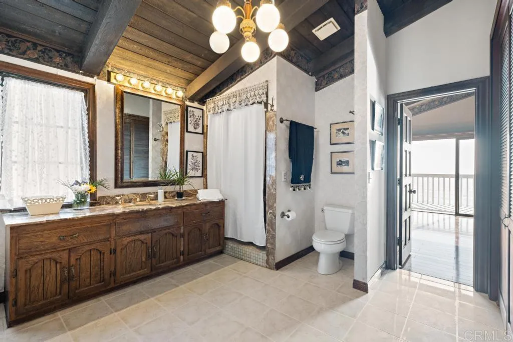 1046 Neptune Avenue Encinitas, CA 92024 - Photo 37 of 49 a large spacious bathroom with a double vanity sink a large mirror and a shower