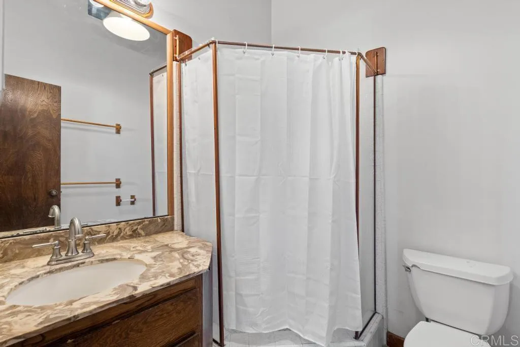 1046 Neptune Avenue Encinitas, CA 92024 - Photo 44 of 49 a bathroom with a granite countertop sink and a mirror