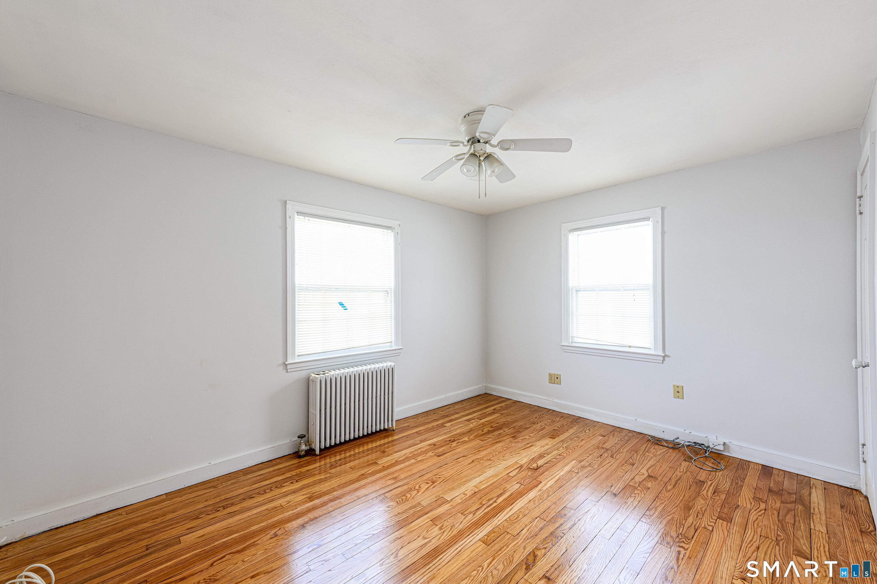 84 Piper Road Hamden, CT 06514 - Photo 13 of 28 a view of empty room with wooden floor and fan