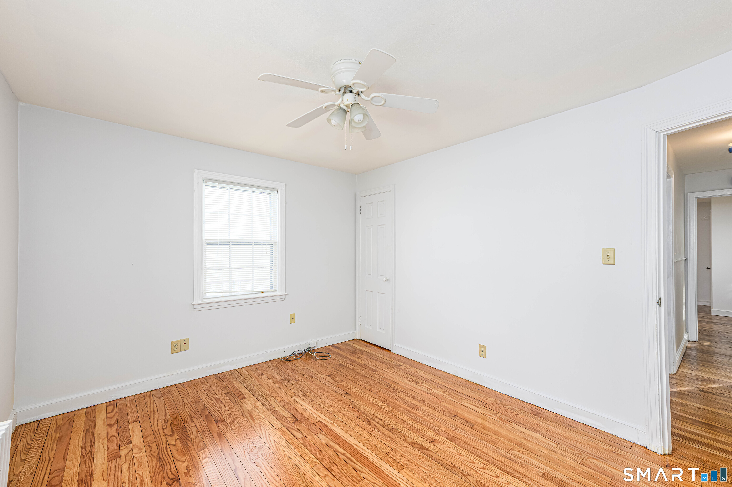 84 Piper Road Hamden, CT 06514 - Photo 14 of 28 a view of an empty room with wooden floor and a window