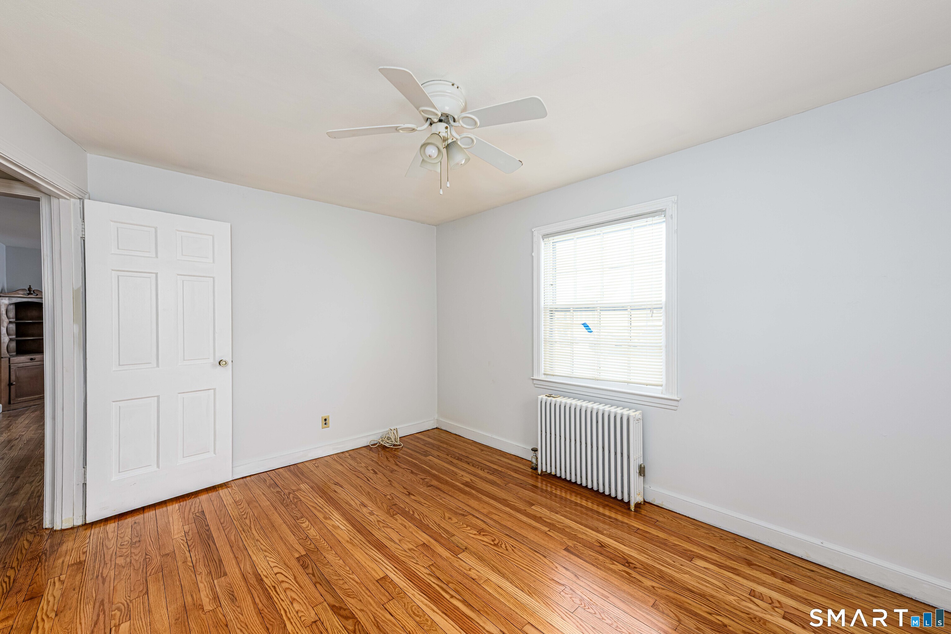 84 Piper Road Hamden, CT 06514 - Photo 16 of 28 wooden floor in an empty room with a window