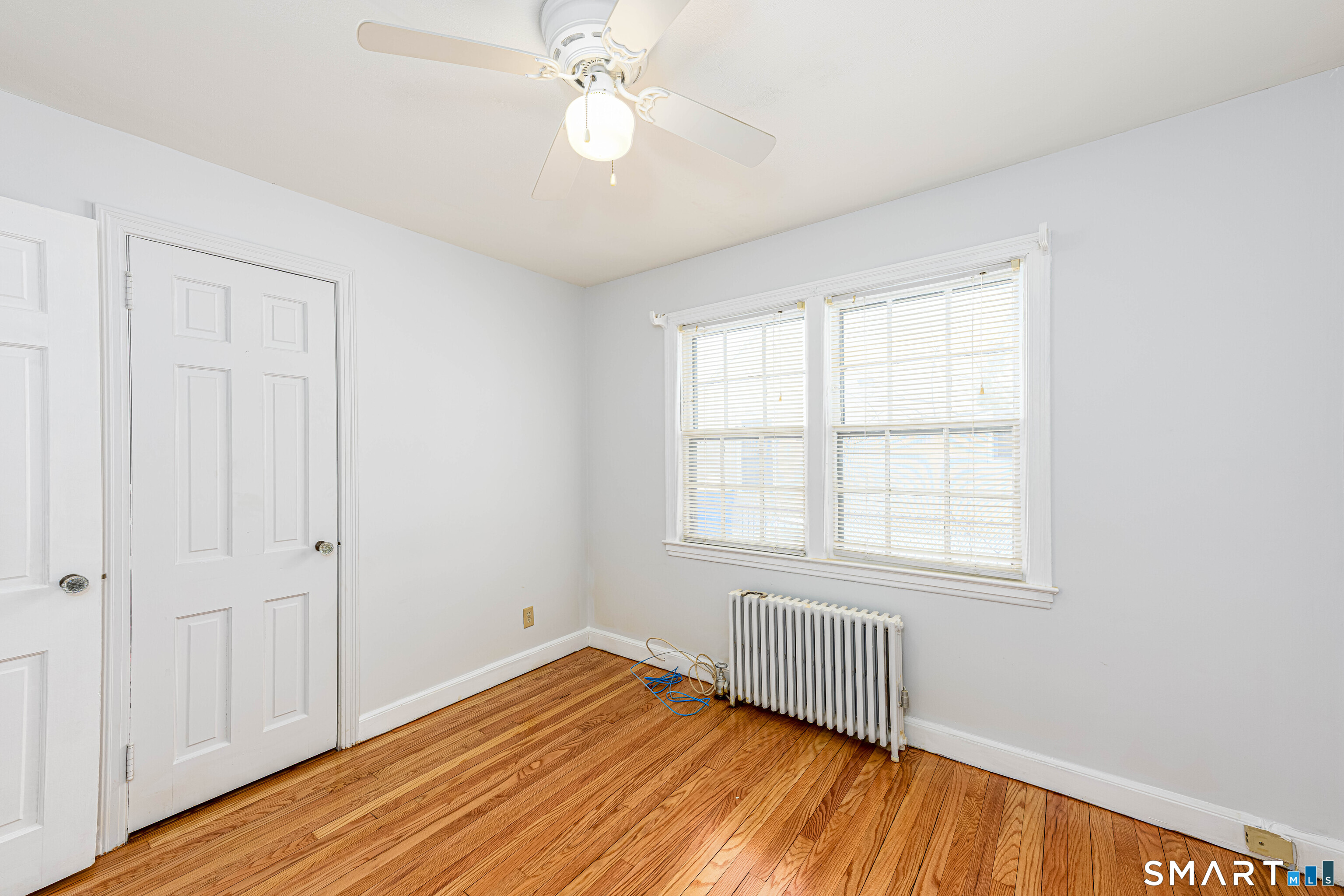 84 Piper Road Hamden, CT 06514 - Photo 21 of 28 wooden floor in an empty room with a window