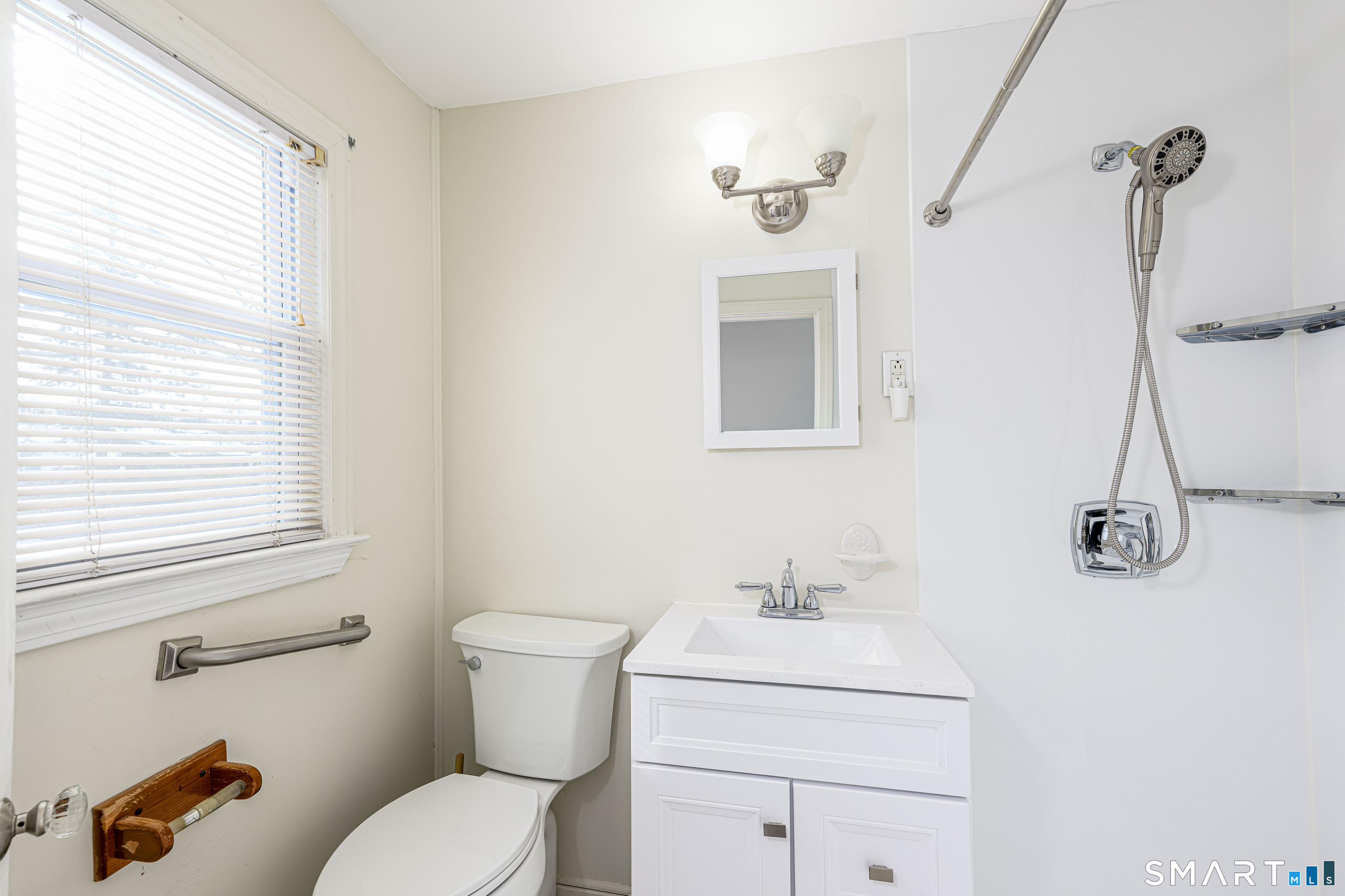 84 Piper Road Hamden, CT 06514 - Photo 22 of 28 a bathroom with a toilet sink vanity and mirror