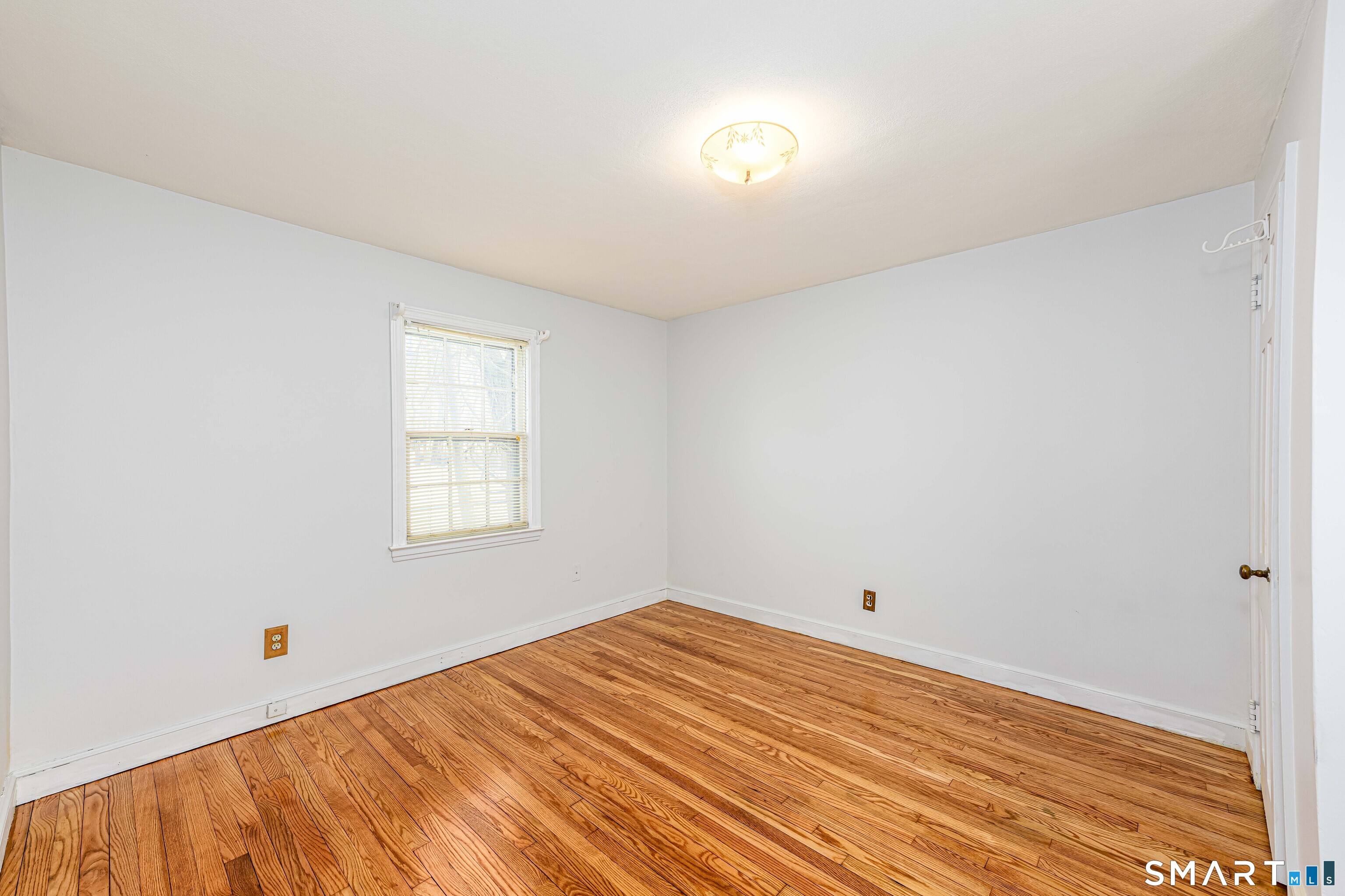 84 Piper Road Hamden, CT 06514 - Photo 23 of 28 a view of empty room with wooden floor
