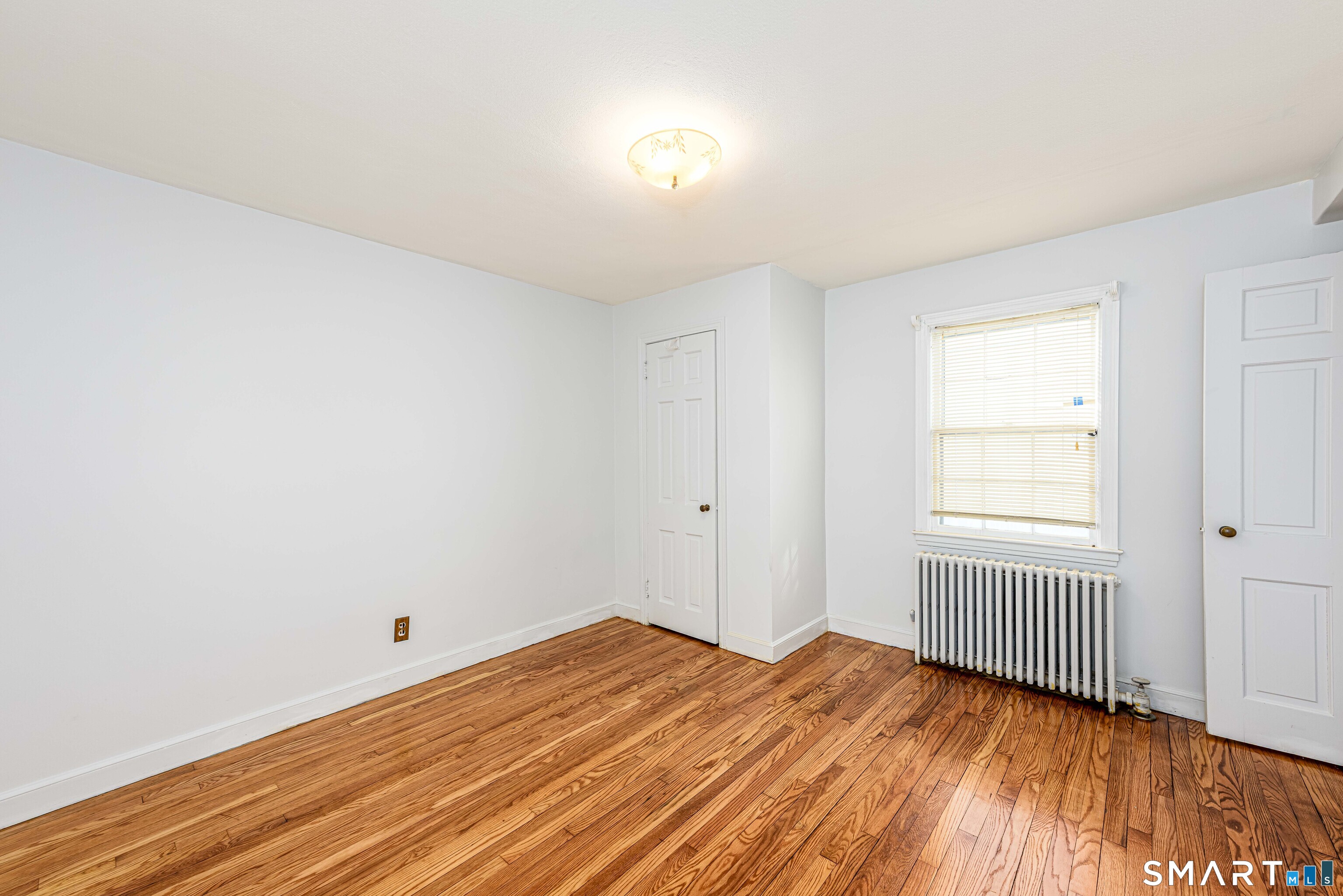 84 Piper Road Hamden, CT 06514 - Photo 24 of 28 a view of empty room with wooden floor and fan
