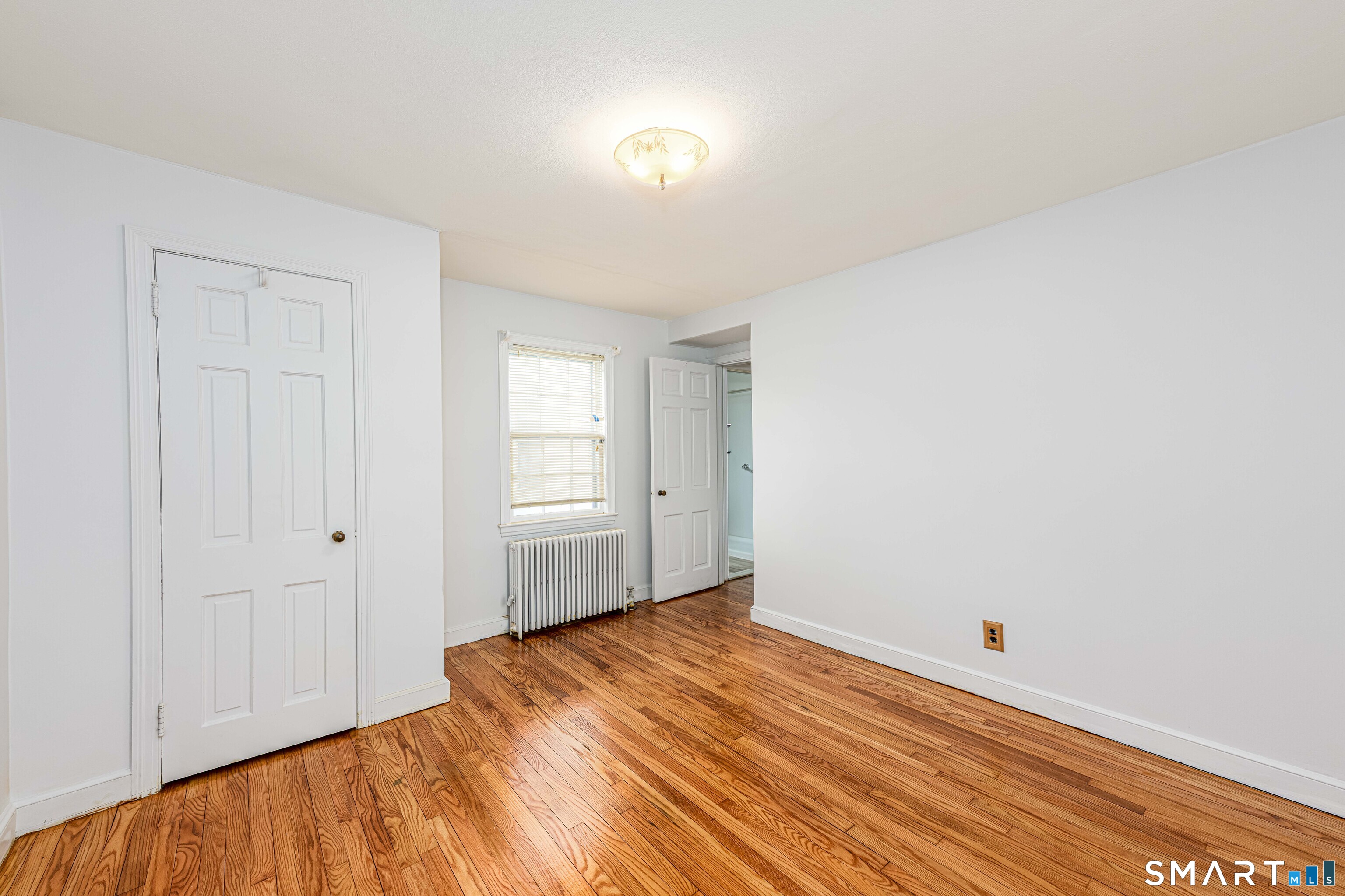 84 Piper Road Hamden, CT 06514 - Photo 25 of 28 a view of a room with wooden floor and white walls