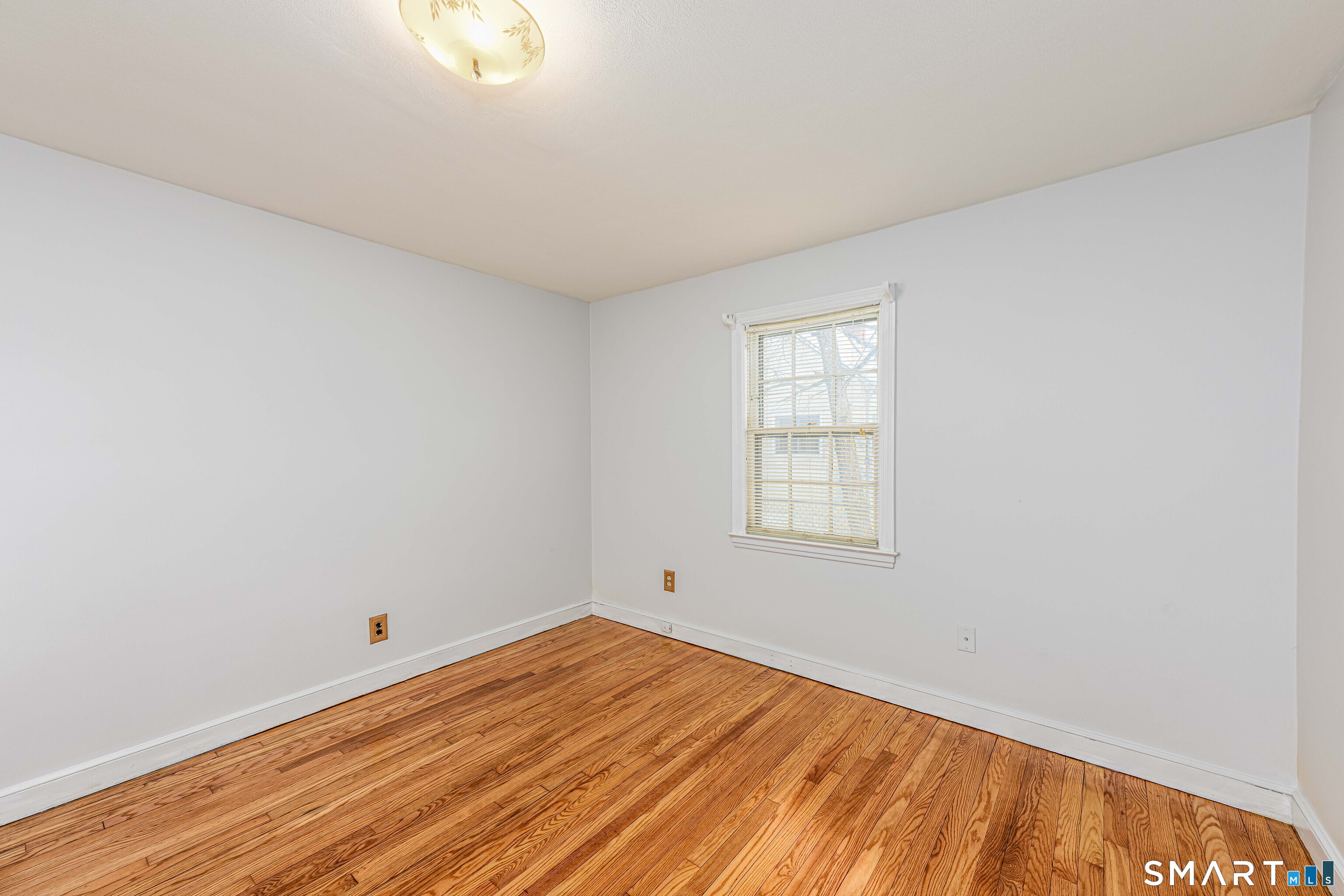 84 Piper Road Hamden, CT 06514 - Photo 26 of 28 a view of empty room with wooden floor and fan