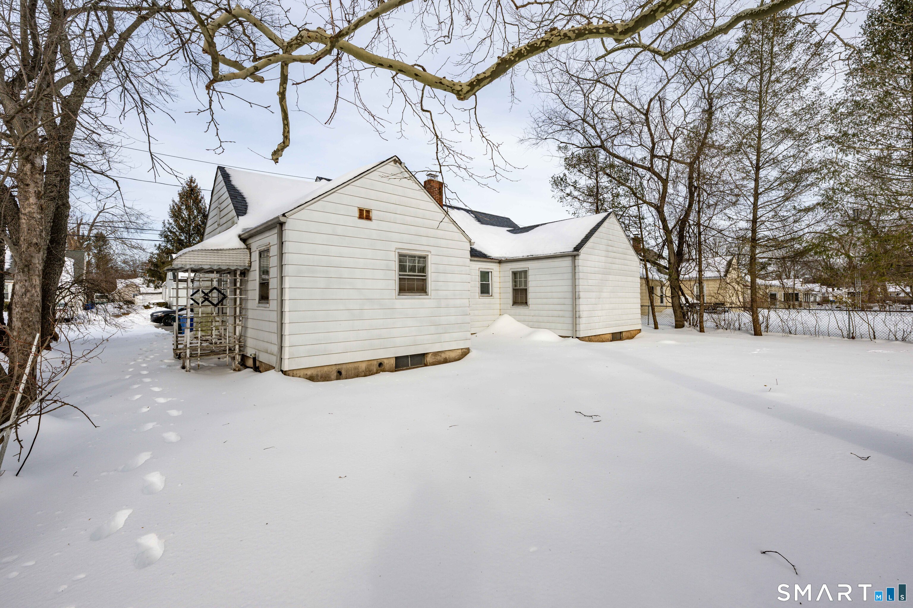 84 Piper Road Hamden, CT 06514 - Photo 27 of 28 a view of a house with a snow in the yard