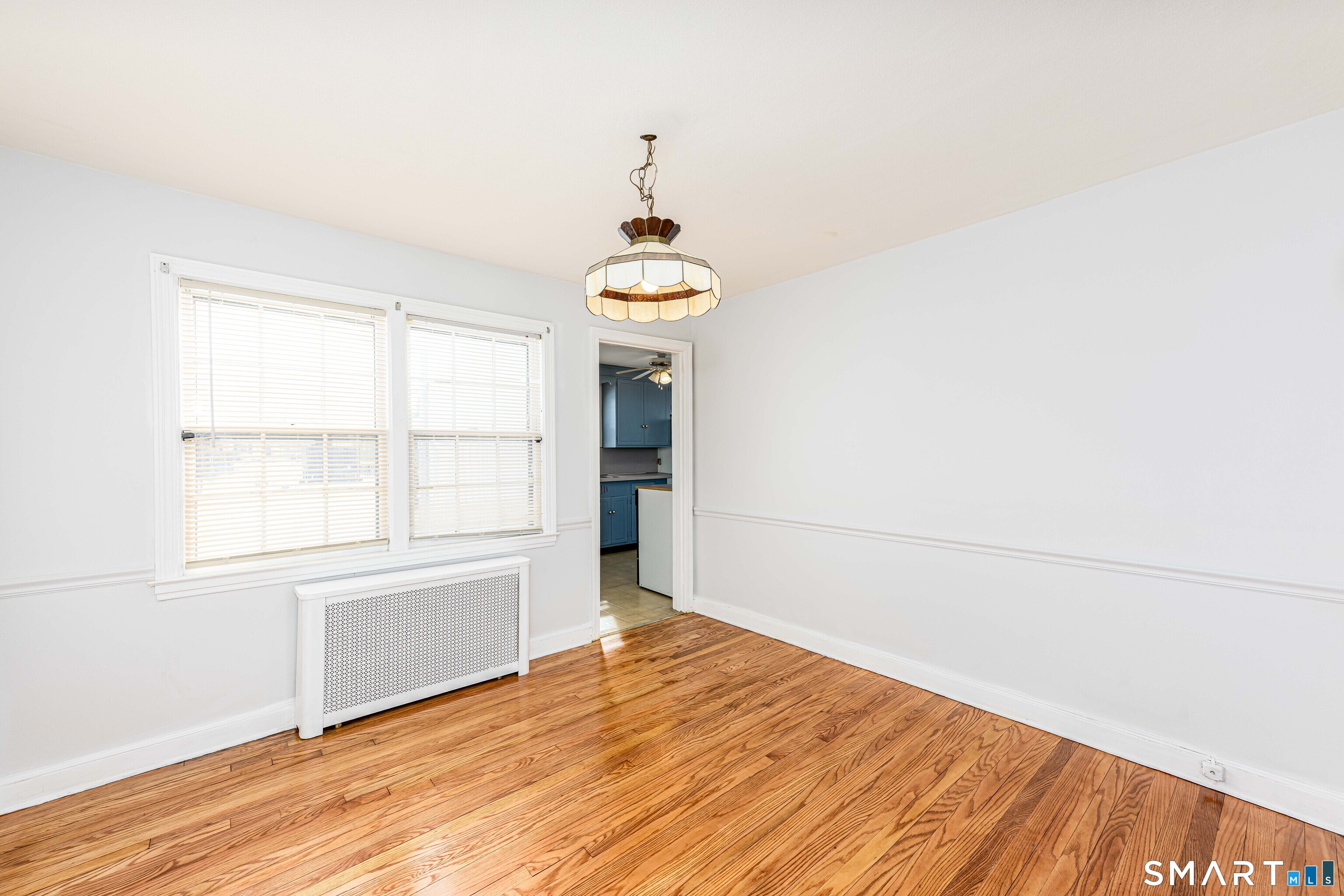 84 Piper Road Hamden, CT 06514 - Photo 7 of 28 an empty room with wooden floor and windows