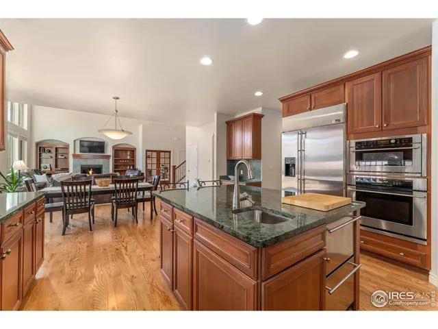 a kitchen with stainless steel appliances granite countertop a stove and a refrigerator