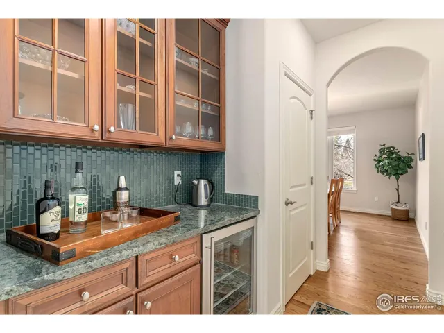 a kitchen with stainless steel appliances granite countertop a sink a granite counter tops and a view of living room