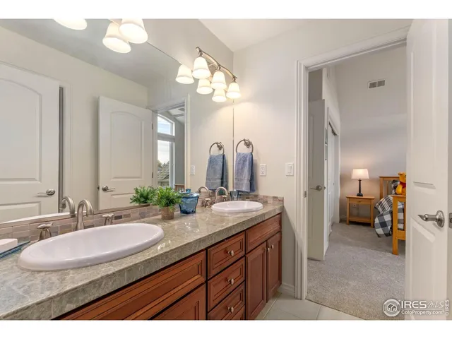 a bathroom with a sink double vanity and a mirror
