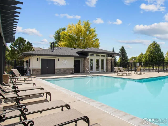 a view of a house with swimming pool and sitting area