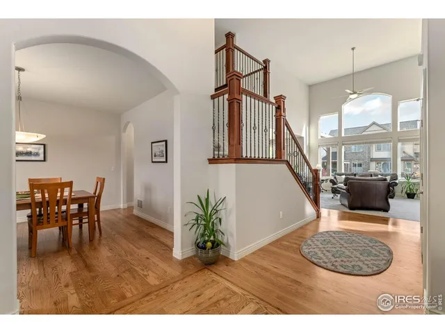 a view of a livingroom and dining room with furniture wooden floor and a chandelier