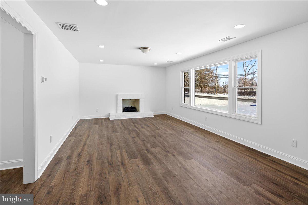 464 Sykesville Road Wrightstown, NJ 08562 - Photo 3 of 32 a view of empty room with wooden floor and fan