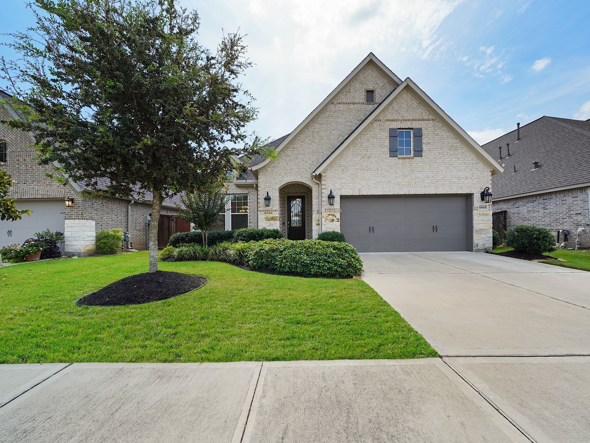 6919 Myrtle Drive Katy, TX 77493 - Photo 1 of 38 a front view of a house with a yard and garage