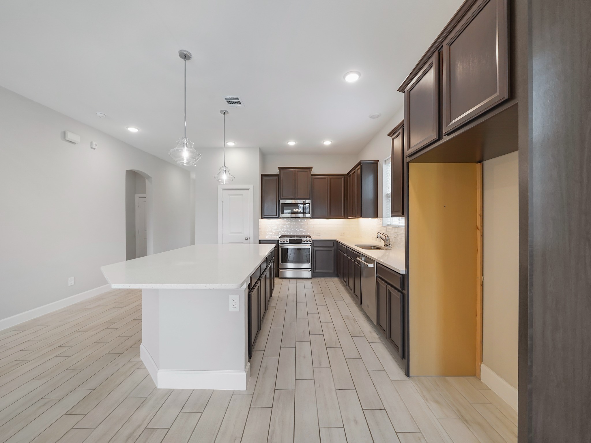 6919 Myrtle Drive Katy, TX 77493 - Photo 11 of 38 a kitchen with stainless steel appliances granite countertop a refrigerator a oven a sink and white cabinets with wooden floor