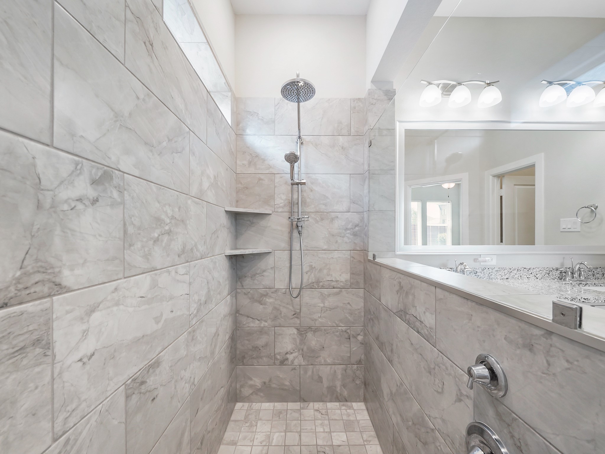 6919 Myrtle Drive Katy, TX 77493 - Photo 26 of 38 a bathroom with a sink shower and a mirror