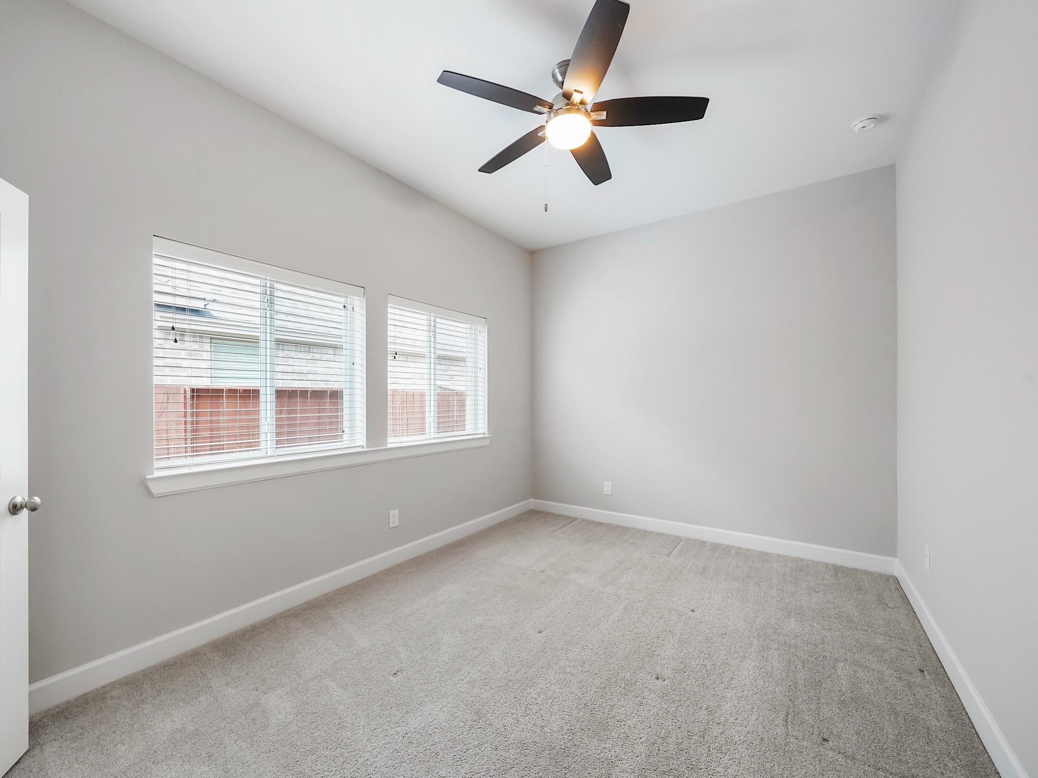 6919 Myrtle Drive Katy, TX 77493 - Photo 28 of 38 an empty room with a window and a fan