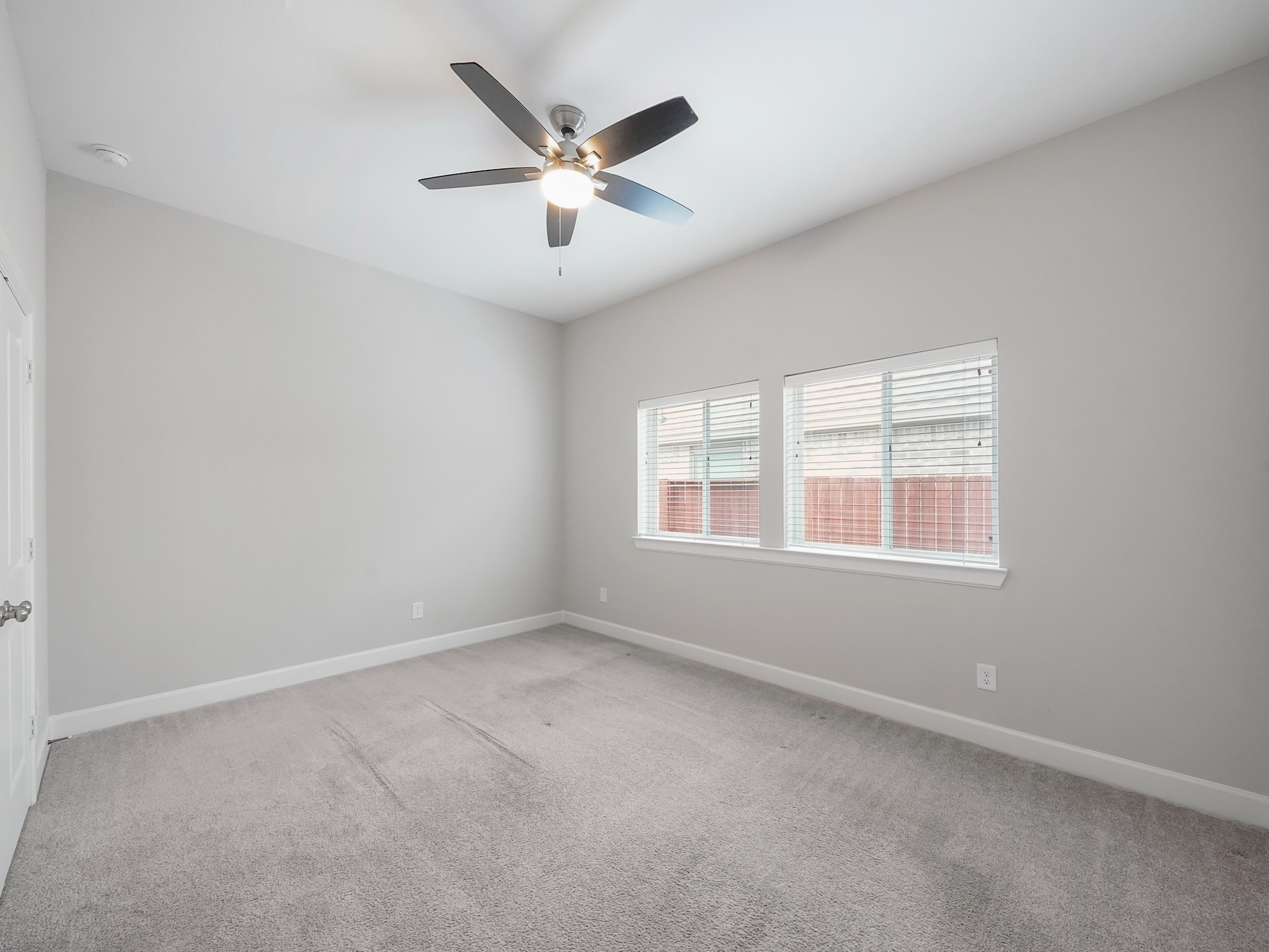 6919 Myrtle Drive Katy, TX 77493 - Photo 30 of 38 an empty room with a window and a fan