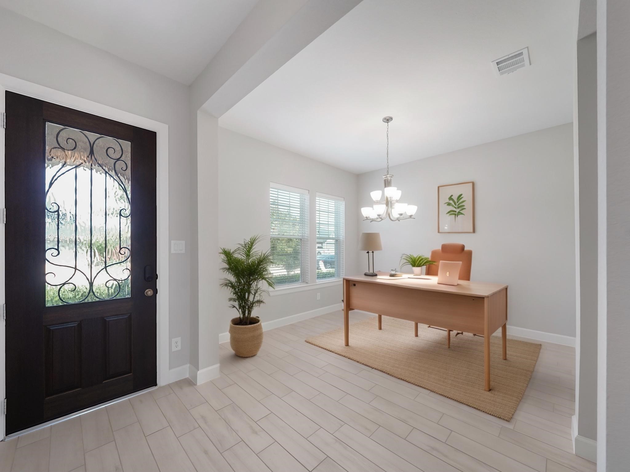 6919 Myrtle Drive Katy, TX 77493 - Photo 7 of 38 a living room with furniture a chandelier and a window