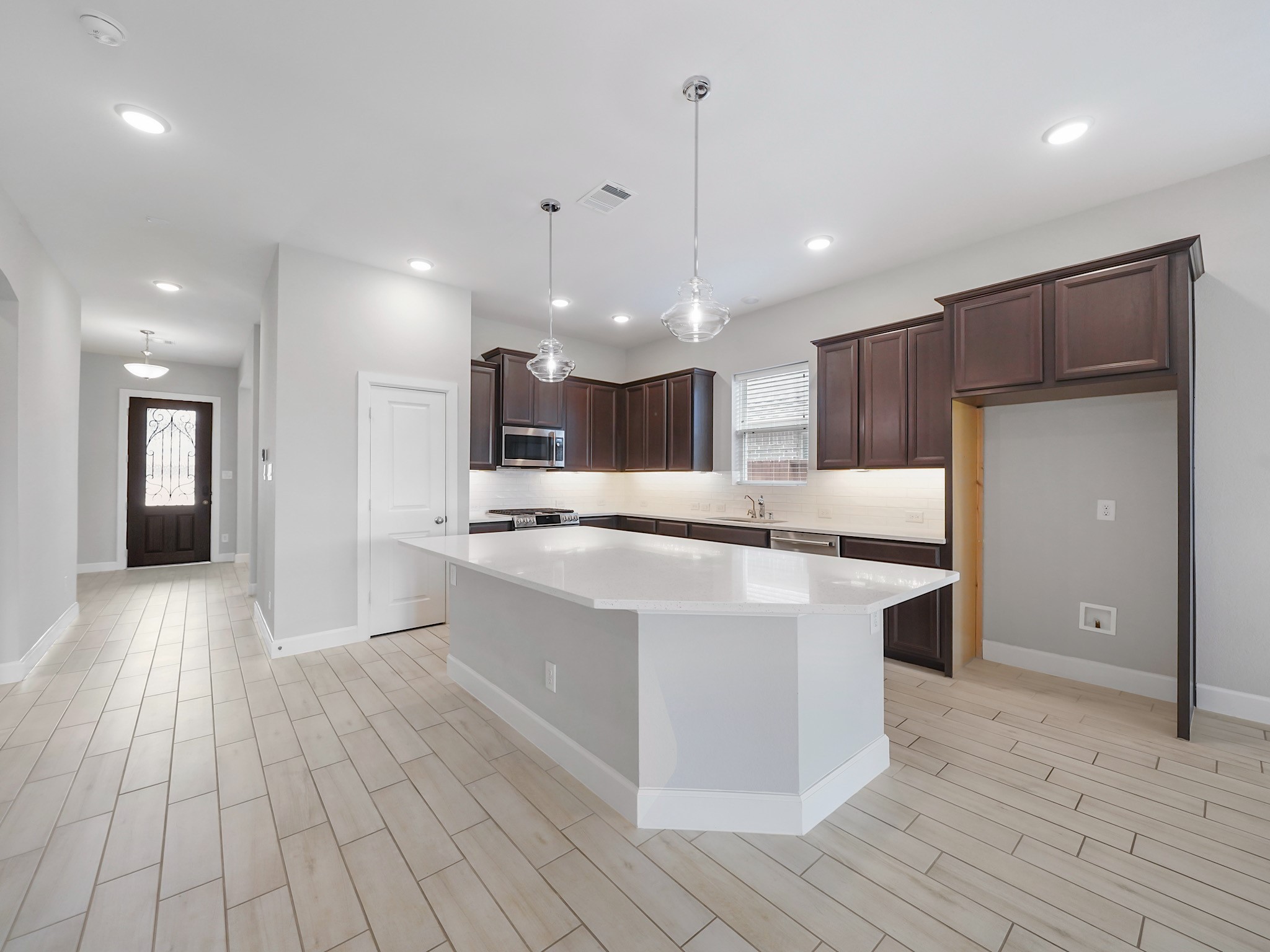 6919 Myrtle Drive Katy, TX 77493 - Photo 10 of 38 a large kitchen with stainless steel appliances kitchen island a large counter top and a wooden floors