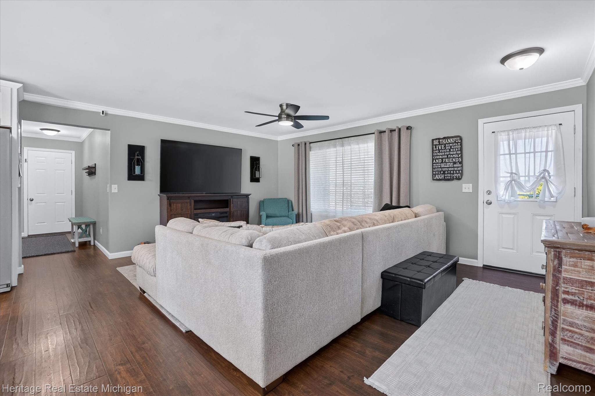 7225 Baldwin Road Swartz Creek, MI 48473 - Photo 5 of 44 Open-concept living area featuring wood-finish flooring, a ceiling fan, and crown molding