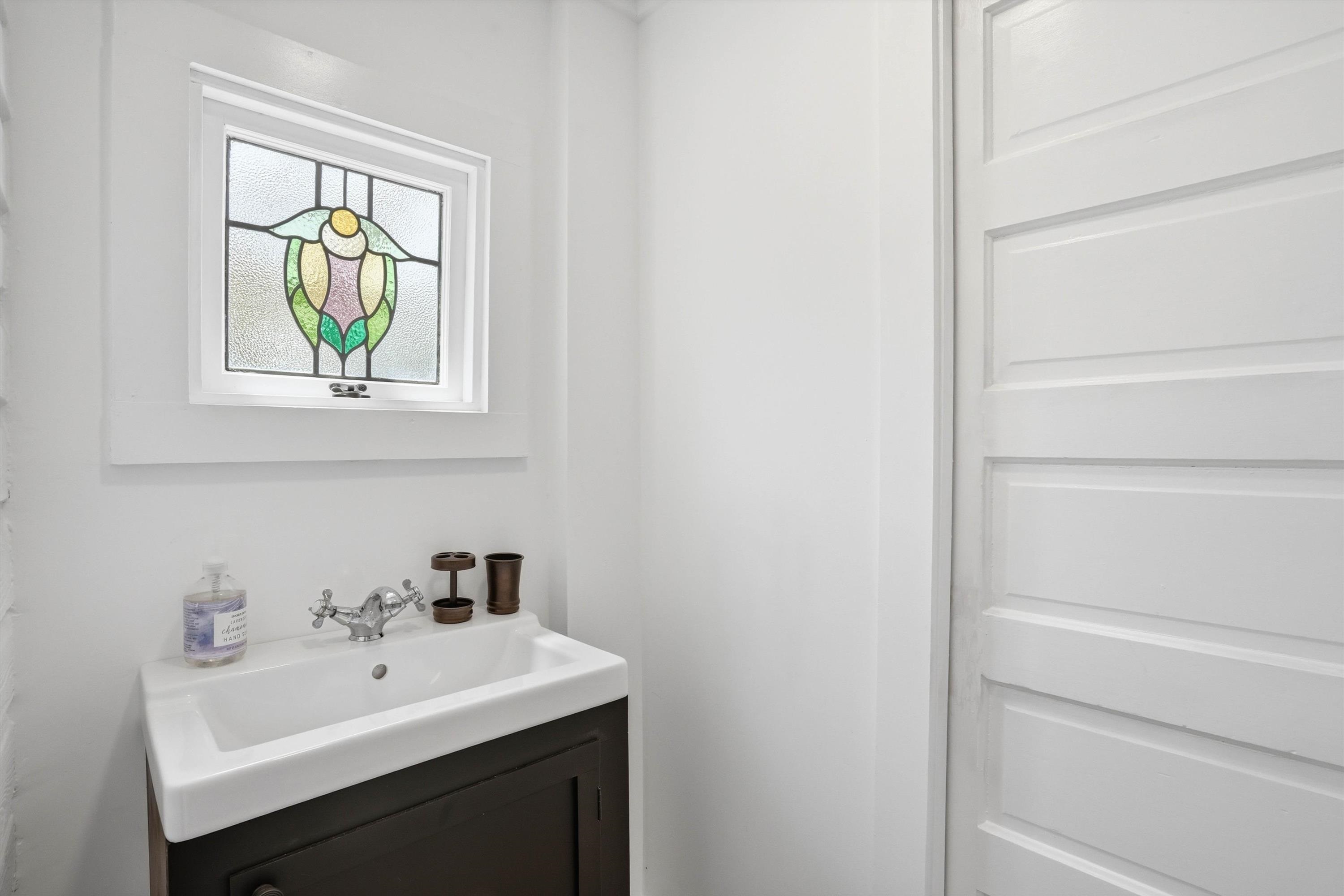 76 Oneida Street St. Augustine, FL 32084 - Photo 16 of 38 a bathroom with a sink and a window