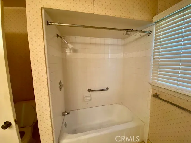 a bathroom with a shower and a bath tub