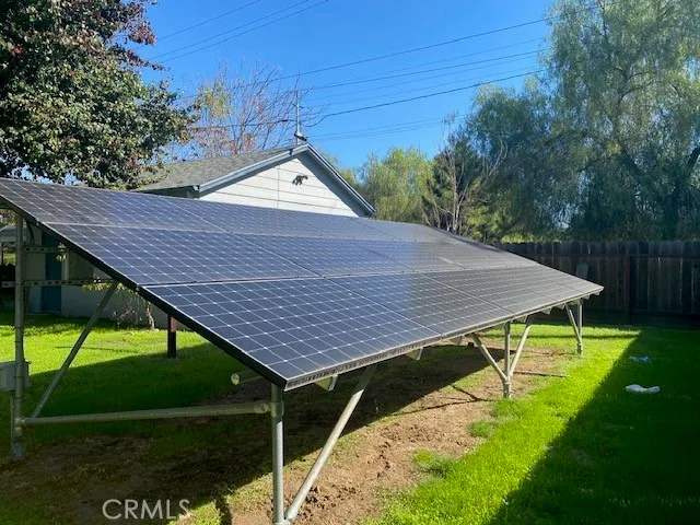 a view of a backyard with table and chairs under an umbrella