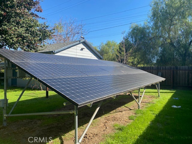 8 West 25th Street Merced, CA 95340 - Photo 14 of 14 a view of a backyard with table and chairs under an umbrella