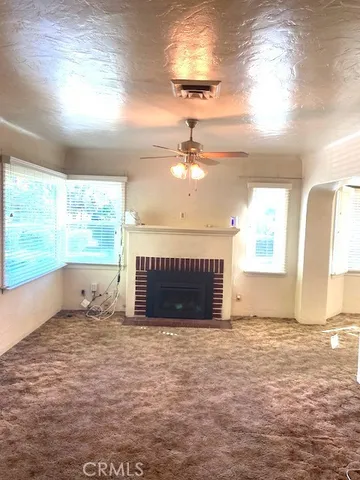 a view of empty room with window and fireplace