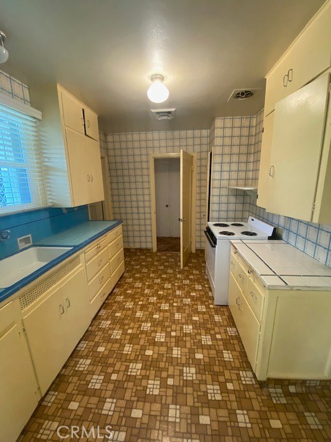 8 West 25th Street Merced, CA 95340 - Photo 6 of 14 a large bathroom with a sink a large mirror and a shower