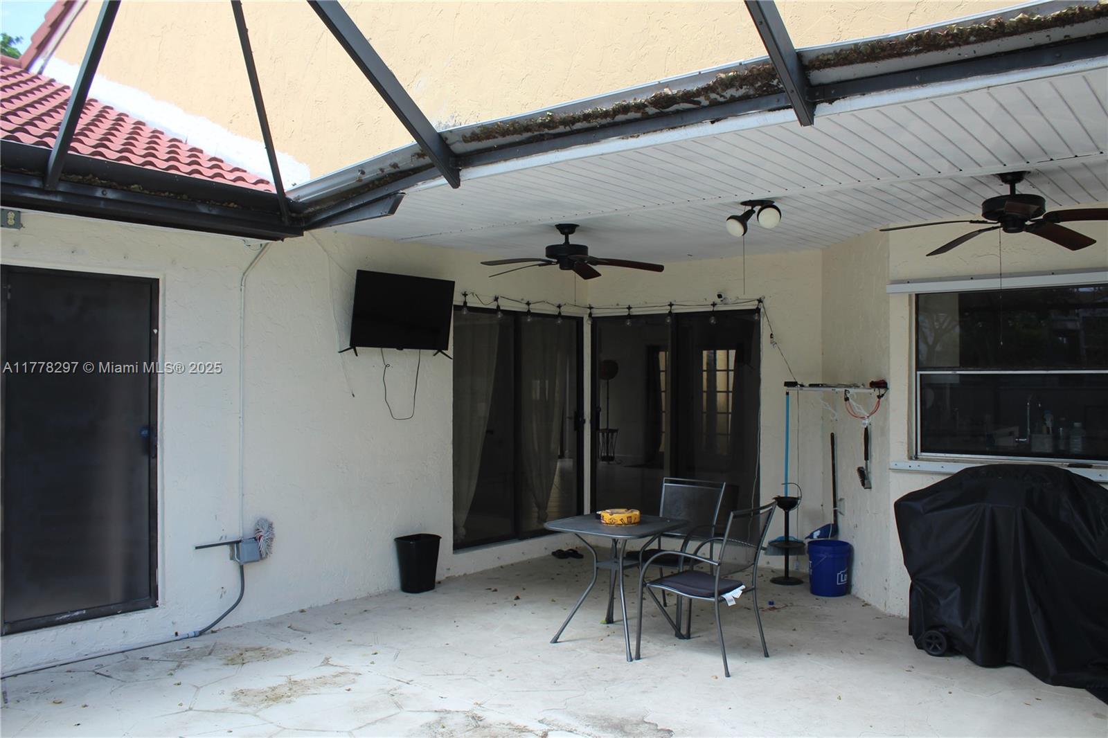17320 Northwest 62nd Place Hialeah, FL 33015 - Photo 13 of 27 a couple of chairs sitting in patio of a house