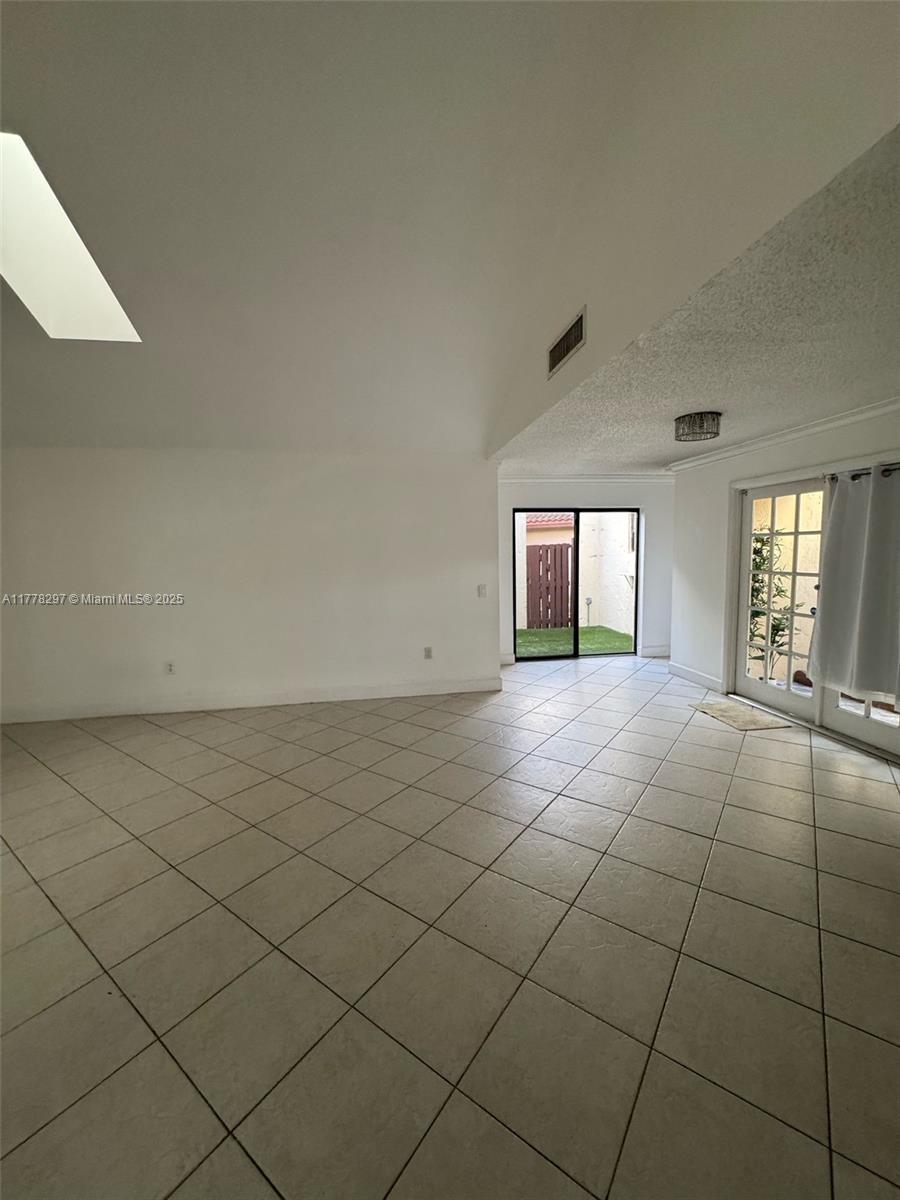 17320 Northwest 62nd Place Hialeah, FL 33015 - Photo 17 of 27 an empty room with windows